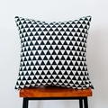 Detail of a square black and white triangle pattern cushion on a wooden stool - Black Triangle