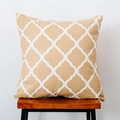 Close-up of khaki Nordic plaid throw pillow with white geometric pattern on a wooden stool - Rhombus Yellow Background