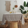 Nordic checkered cotton linen tablecloth with white tassel edge on a wooden table - 140x140 / Khaki