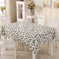 Close-up of Nordic style tablecloth featuring small green tree patterns on beige fabric - Small Square / Forest