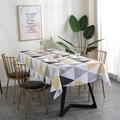 Nordic waterproof tablecloth with yellow and grey geometric triangles on a black dining table - Coffee Triangle
