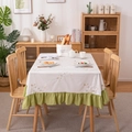 Floral embroidered cotton tablecloth with green ruffle hem in a cozy dining room - Tri-Color Flowers with Green Ruffle