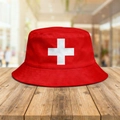 Reversible red bucket hat featuring a white cross design on a wooden background - M (56-58cm) / Swiss