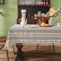 Bohemian striped table runner with geometric patterns and white fringe on a wood table - Ethnic Pink Stripe + Tassel / 60x60cm
