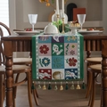 Easter table runner with woven jacquard rabbits, colored eggs, and tassels on a wood table - 35x120cm / Square Bunny with Green Tassels