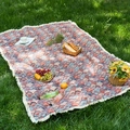 Outdoor jacquard picnic blanket with tassel edges on green grass with picnic basket - Red Blue Ginkgo + Dense Tassels
