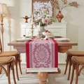Red and white jacquard table runner with circular petal patterns and cream tassels - Red Mandala