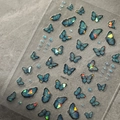 Macro detail of laser holographic butterfly nail stickers with metallic blue iridescent finish - YT3657 Shell Luster