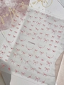 Self-adhesive nail sticker featuring red dotted bow patterns on a soft pink background - Red Bowknot (YT7668Ho)
