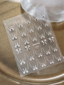 Detalle macro de pegatinas de lazos plateados para uñas con texto YT5594 Pro - Lazo Plateado Estampación en Caliente (YT5594 Pro)