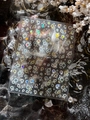Macro shot of iridescent rainbow bubble and star nail stickers on a textured black surface - Shell Light (YT6218Te)