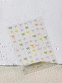 Detail von bunten Makronen-Bogen-Nagelaufklebern auf einer transparenten Folie - Macaron-Schleife (YT5531Pro)