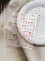 Detail of colorful hand-drawn bow nail art stickers on a decorative ceramic plate - Embossed Colorful Hand-drawn Bow (YT6254)