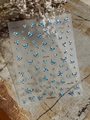 Detail of laser silver and dark blue butterfly nail art stickers on a textured background - Silver Laser YT6334pro