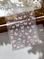 Detail of pink iridescent butterfly nail stickers with crystal accents on a grey background - Pink Butterfly Style (YT6081)