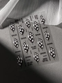 Macro shot of Gothic nail stickers with black horror face patterns and Spider text detail - Relief Style (YT6530)