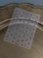 Detailed view of laser blue star nail art stickers on a metallic tray, model YT5534Pro - Star Pattern Style (YT5534Ls) / Silver Holographic