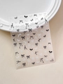Detail of YT5502 black and white bow nail stickers on a white ceramic plate - Black and White Style Bow (YT5502Pm)