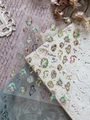 Macro view of melting clock nail stickers with vintage Christmas tree and gold foil details - Gold Membrane YT6541Hj