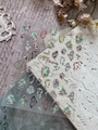 Detail of Christmas nail stickers featuring melting clocks and green festive trees - Silver Foil YT6542Si