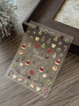 Macro detail of 5D embossed Christmas cookie nail stickers with gingerbread man designs - Embossed YT6551