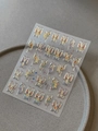 Macro shot of colorful metallic butterfly nail art stickers with gold foil outlines - Bronzing Gold (YT6741Me)