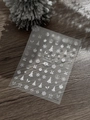 Close-up of white embossed 5D Christmas nail stickers with snowflakes and reindeer - Embossed White Pattern (YT6580)