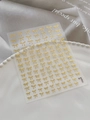 Detailed view of 3D gold bow nail stickers on translucent backing over elegant pearl tray - Gold Film Golden Style (YT6249)
