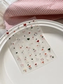 Embossed heart nail art stickers with red and black designs on a white ceramic plate - 3D Relief Red Black Heart Style (YT6502)