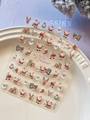 Macro shot of 3D embossed Christmas nail art stickers featuring Santa and reindeer designs - Embossed Santa Claus (YT6578)
