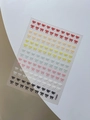 Macro shot of colorful 3D embossed bow nail stickers in seven vibrant shades, model YT6004 - Embossed Multicolor Style (YT6004)