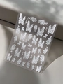 Macro shot of 3D embossed white nail stickers with floral and butterfly patterns - White Butterfly Floral Embossed Style (YT5431)