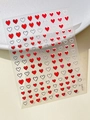 Close-up of red and silver heart nail art stickers with metallic gold stars finish - Red Silver Edge Heart (YT5816Si)