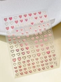 Close-up of pink and gold heart star nail art stickers on a textured leather background - Pink Gold Outline Heart (YT5813Me)