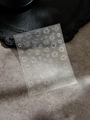 Detail shot of laser silver firework and floral nail art stickers on a gray texture - Silver Stamping (YT4257si)