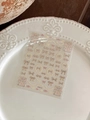 Detail view of embossed bow and pearl nail stickers on a white ceramic plate - Red And Gold Bow Plaid Style (YT4775)