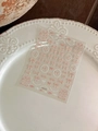 Close-up of 3D embossed nail stickers featuring bowknots and pearl chains, model YT4774 - Pink And White Plaid Bow Style (YT4774)