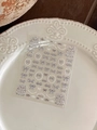 Close-up of bow nail art stickers with pearl details and grey plaid patterns on white plate - Grey Plaid Bow Style (YT4773)