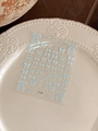 Detail of 3D light blue ribbon and pearl chain nail art decals on white ceramic plate - Light Blue Pearl Bow Style (YT4780)