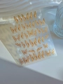 Detail of Butterfly Dream nail stickers with gold foil outlines and bow designs - Nude Pink Gold Butterfly (YT4897)