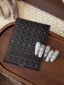 Close-up of star and moon nail stickers on silver glitter nails over a wooden tray - Celestial Geometric (YT83)