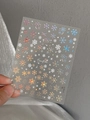 Macro shot of laser snowflake nail stickers with holographic shimmer and back adhesive - Holographic Snowflake Style (YT4679mc)