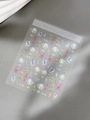 Detailed shot of iridescent bow and shell-light flower nail art stickers on a textured base - Hand-painted Bouquet Ribbon Style (YT4960TePro)