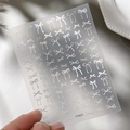 Self-adhesive nail art stickers featuring white embossed bow designs on a frosted sheet - Embossed White Style (YT5025)