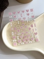 Macro detail of 3D embossed nail stickers with pink bow and candy patterns, YT4211 design - Relief YT4211 (Pink White Heart Lollipop)