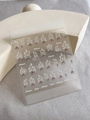 Macro detail of YT4140 floral nail stickers with white flowers and brown ribbon motifs - Gold Embossed YT4140Me