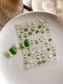 Close-up of 3D embossed green apple nail art stickers with small white floral details - Green Apple Pattern (YT4548)
