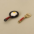 Miniature dollhouse frying pan with fried egg and gold spatula featuring red handles - Frying Pan And Spatula