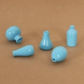 Set of five miniature light blue ceramic dollhouse vases with a glossy polished glaze - Blue