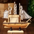 Handcrafted Mediterranean style wooden sailboat model on desk with striped canvas sails - Sailboat Model Style